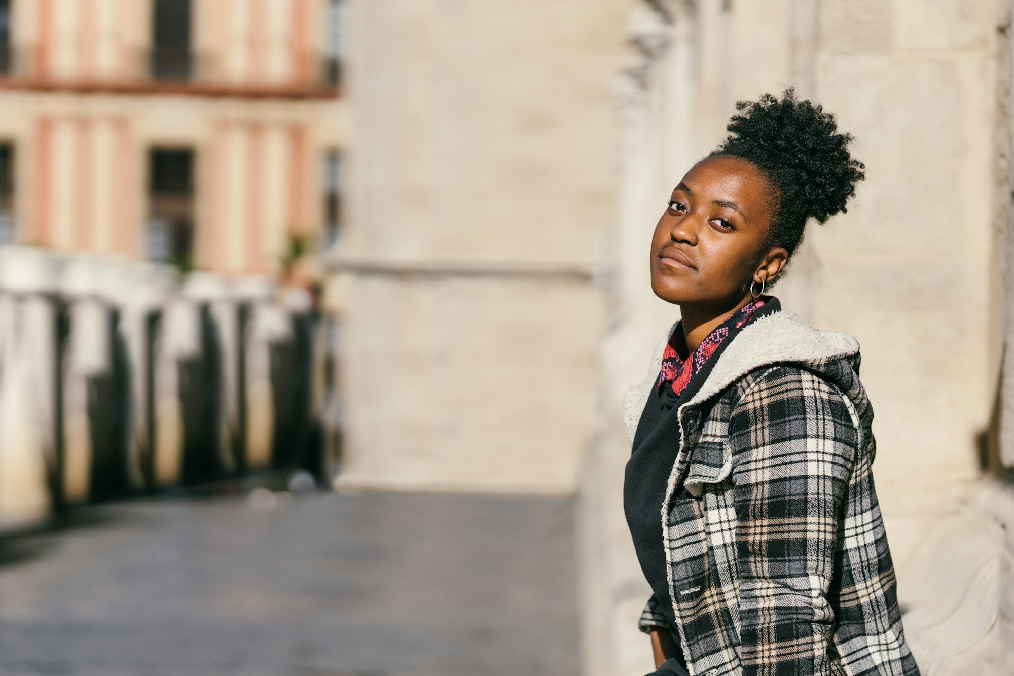 Portrait of a teen african woman facing the camera with serious expression